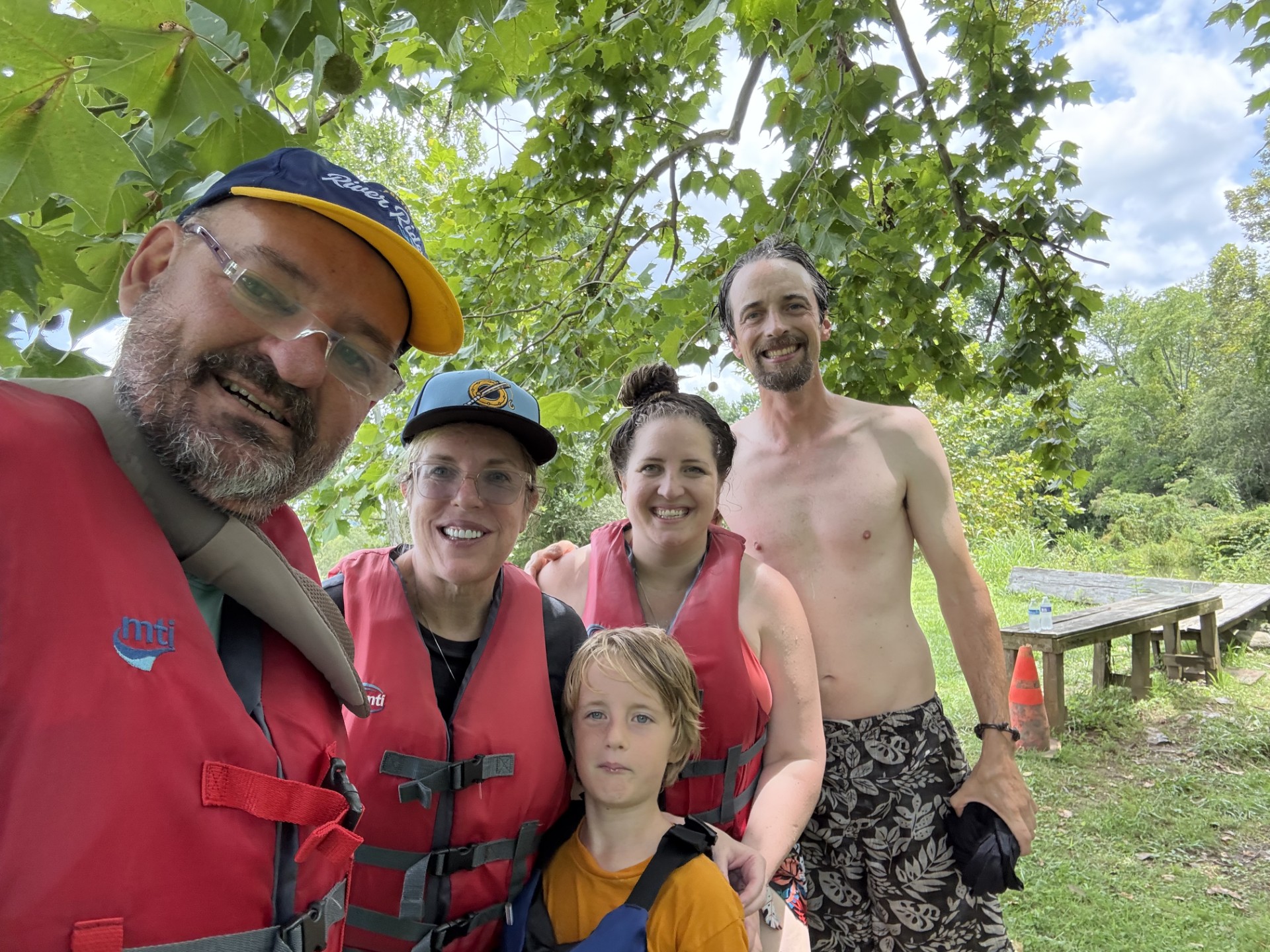 Family in PFDs side by side at the River House — River House hat