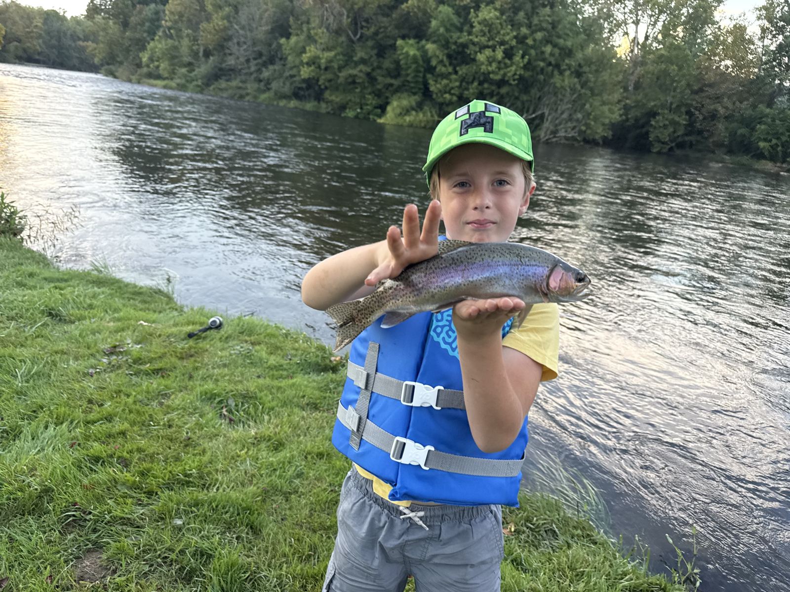 Rudy Stone with a rainbow trout caught off the River House dock